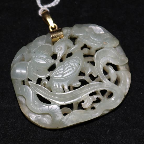 A Chinese celadon jade crane and lotus openwork plaque, Ming dynasty, 4.7cm, later gold mount